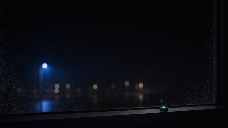 A phone glowing on a dark desk at night, answered while the office is closed
