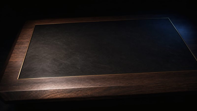 A phone face down on a dark wooden desk, seconds from ringing