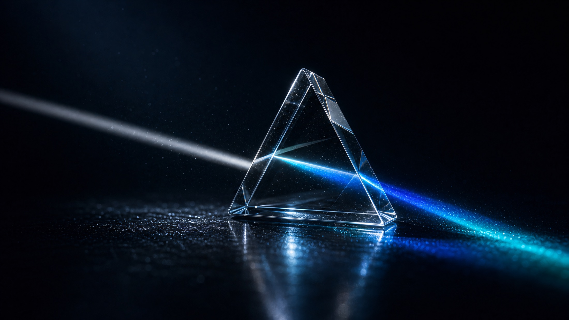 A beam of light splitting through a glass prism on a dark surface